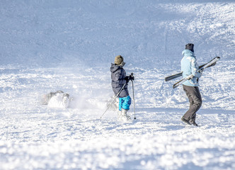 Fototapeta na wymiar Skiing from the mountain - Falling skier on the mountainside at the ski resort