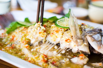 Steamed thai flavor sour and spicy fish served on the plate