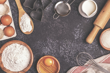 Fototapeta na wymiar Ingredients for baking - flour, wooden spoon, rolling pin, eggs