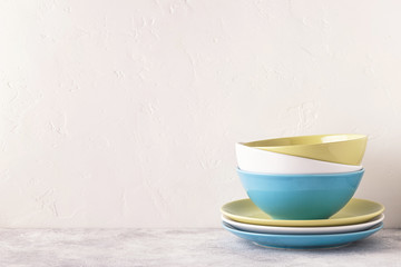 Crockery and cutlery on a light table.
