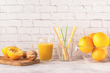 Oranges and juicer for making orange juice.