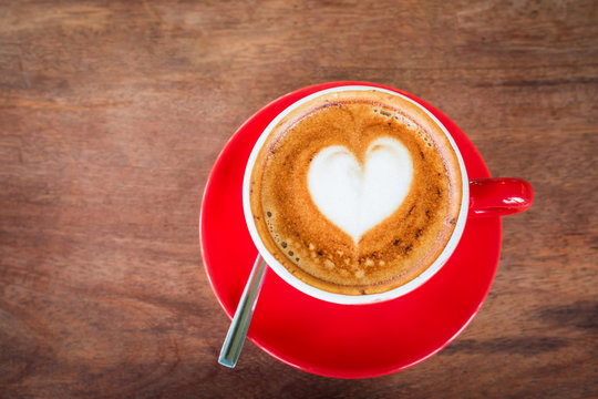 top view Heart latte art hot coffee on old wooden table as love, romantic and valentine's day concept