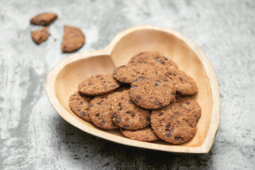 Traditional chocolate chip cookies on heart shape plate.