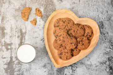 Traditional chocolate chip cookies on heart shape plate.