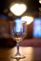 Empty glass on table in night club or restaurant, closeup