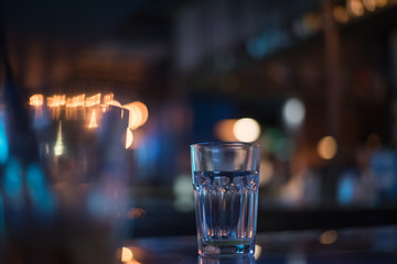 Empty glass on table in night club or restaurant, closeup