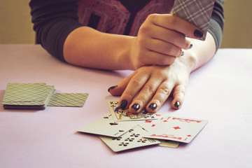 Woman playing cards in her hand