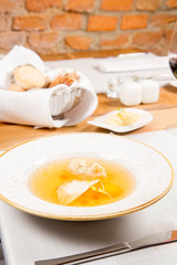 Dumplings in broth with an egg yolk served in a restaurant