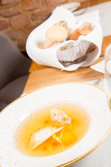 Dumplings in broth with an egg yolk served in a restaurant