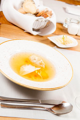 Dumplings in broth with an egg yolk served in a restaurant