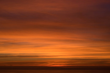 Fototapeta na wymiar Sunset and yellow clouds on the sea