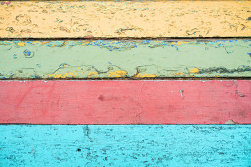 Obraz premium Wooden old background of boards, multicolor striped bright yellow pink sky blue red