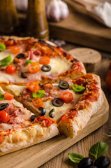 Rustic pizza with tomato, cheese, salami