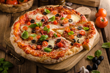 Rustic pizza with tomato, cheese, salami