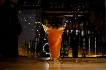 slice of grapefruit fell with a spray into an alcohol cocktail