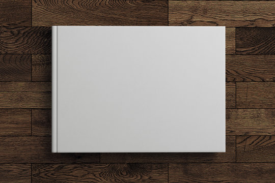 Blank white book on wooden background
