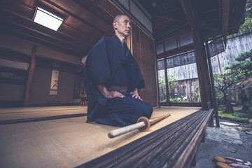 Japanese man meditating in his garden