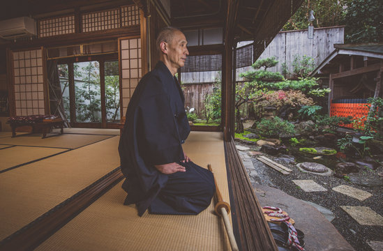 Japanese man meditating in his garden