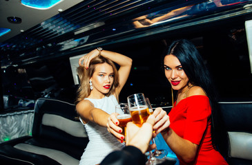 Beautiful girls making party in the limousine