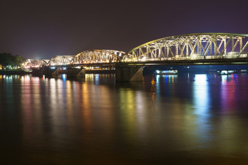bridge at night with colorful light reflections