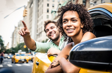 Happy couple on a yellow cab in New york