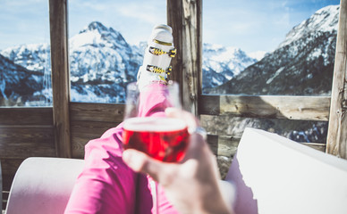 woman relaxing with a glass of wine and enjoying the mountain landscape