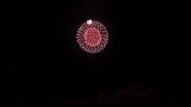 Gorgeous 4k shot of colorful bright illumination firework festival bursting explosion in dark night sky