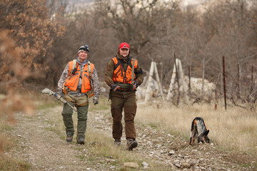 hunters with dogs hunting a bird woodcock