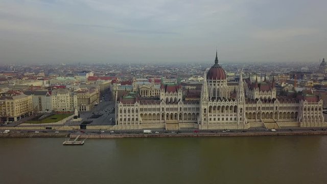 Budapest, Hungary - Aerial drone footage of the Parliament of Hungary with sightseeing boat on River Danube