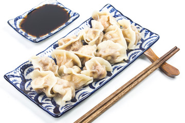 Fresh dumpling on plate. Chinese food with hot steams on background.