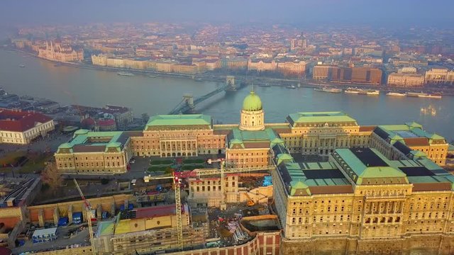 Budapest, Hungary - 4K aerial drone footage of Buda Castle Royal Palace with famous Szechenyi Chain Bridge and Parliament of Hungary at sunset