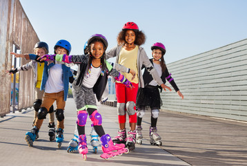 Happy little roller skaters having fun outdoors © Sergey Novikov