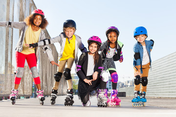 Happy kids rollerblading outdoors at sunny day © Sergey Novikov