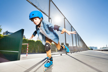 Boy in roller blades doing tricks at skate park