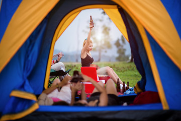 Obraz na płótnie Canvas group of adventure tourist cheerfully camping tent by playing replax together and barbecue