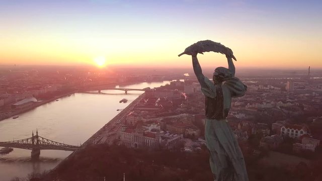 Budapest, Hungary - 4K aerial drone footage at sunrise of drone flying around of Statue of Liberty at Citadella
