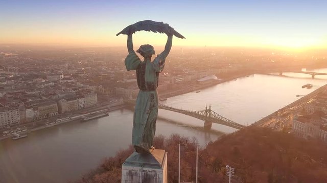 Budapest, Hungary - 4K aerial drone footage at sunrise of drone flying around of Statue of Liberty at Citadella