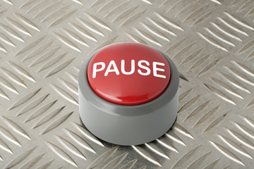 Red Push Button Labeled 'Pause' on Aluminum Diamond Plate Background