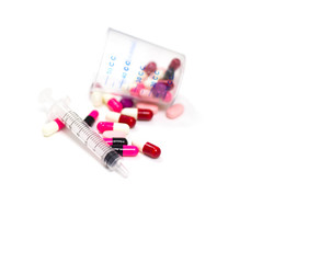the pile of pills and capsules, a syringe with isolated white background copy space