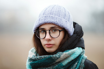 Close up winter portrait young cute brunette girl strolling winter forest park.