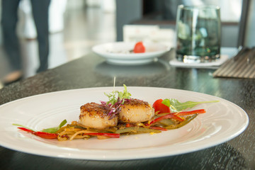 Grilled scallops on a white plate