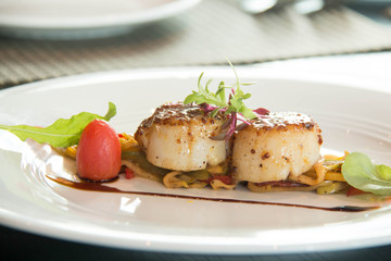  Grilled scallops on a white plate