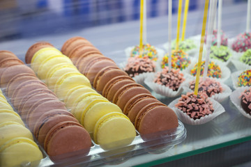 Macaroones -chocolate and lemon cakes.Sweet cakes in shop window cafe