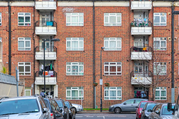 Fototapeta na wymiar Facade of a block apartment at the end of street in London