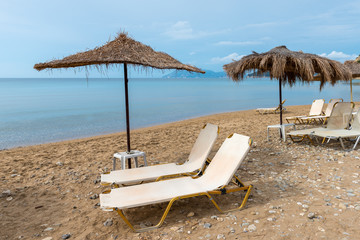 Sunbeds and parasols on beautiful Gerakas beach. Zakynthos island. Greece.