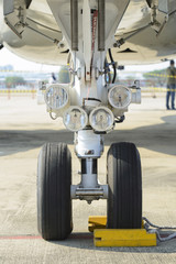 Front landing gear and aircraft lights - obrazy, fototapety, plakaty