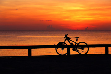 Naklejka na ściany i meble Silhouette bicycle outdoors against sunrise