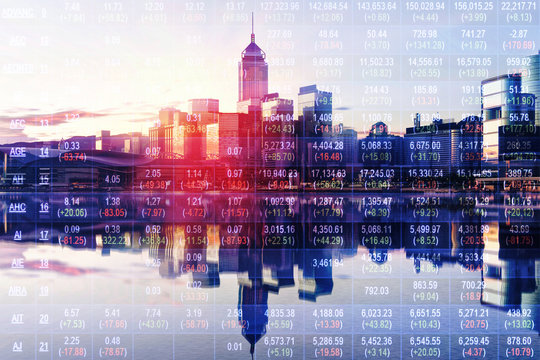 Double exposure of stocks market chart in blue on LED display concept with city scape hong kong background