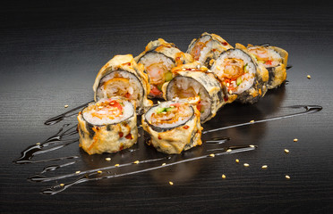 Sushi with seafood isolated on wood black background with reflection. Japanese cuisine.