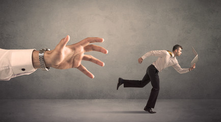 Businessman running from hand